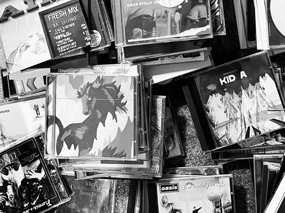 Various piles of compact discs