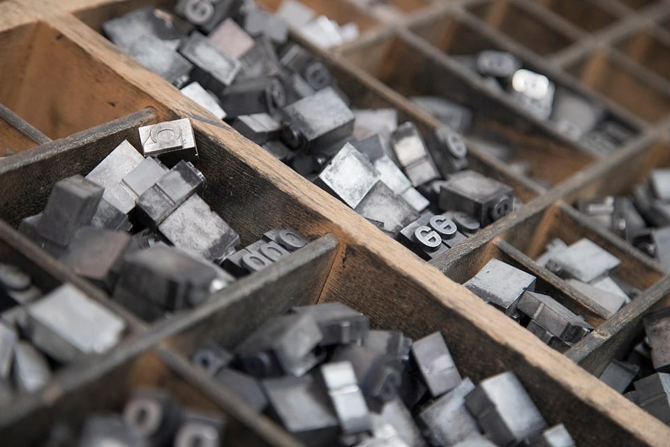 Close up photo of lower case lettering in a typesetter tray